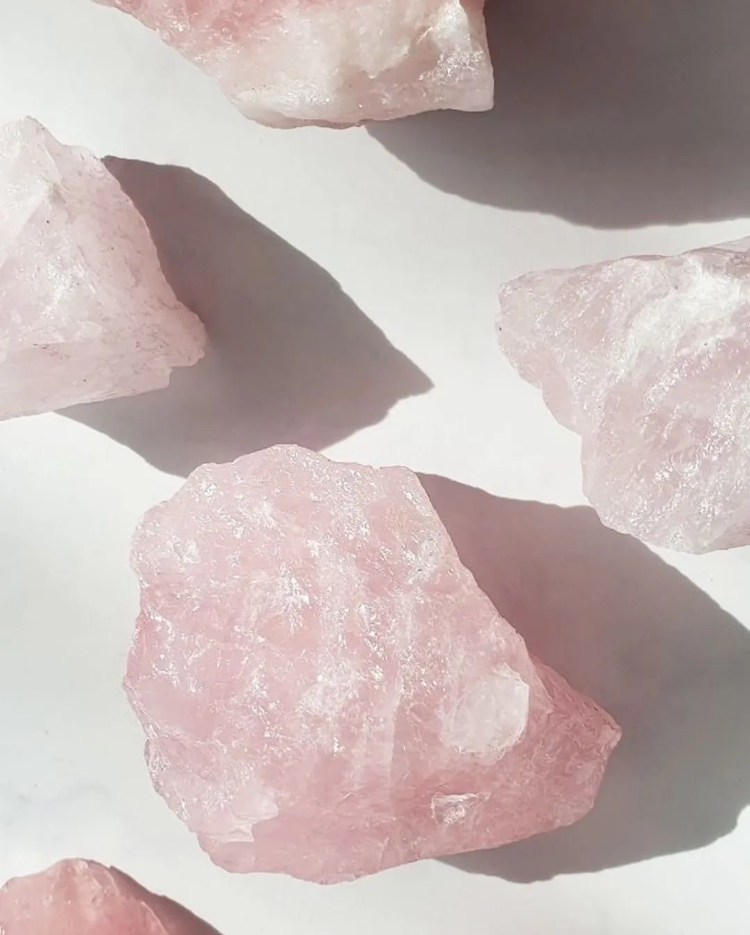Soft pink Rose Quartz crystal glowing with gentle healing energy for heartbreak recovery