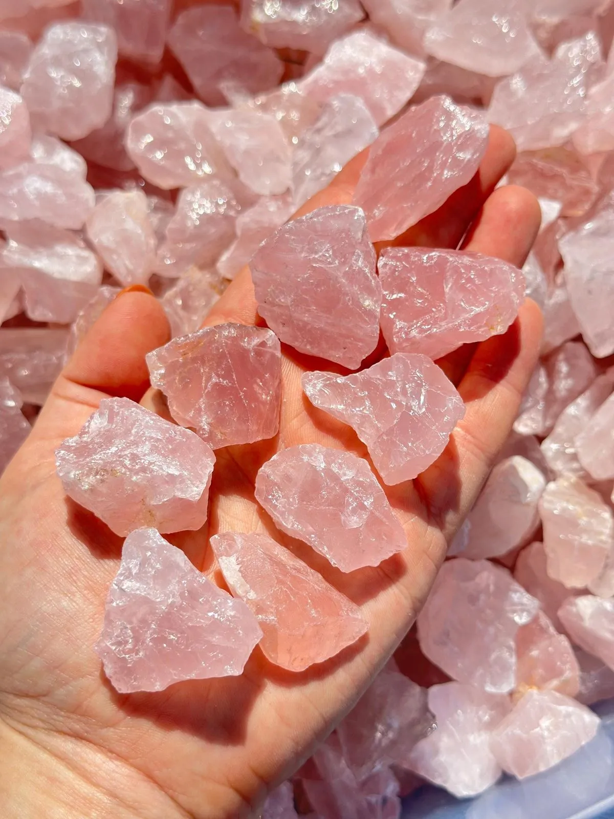 Historical rose quartz carvings and jewelry pieces from different cultural traditions