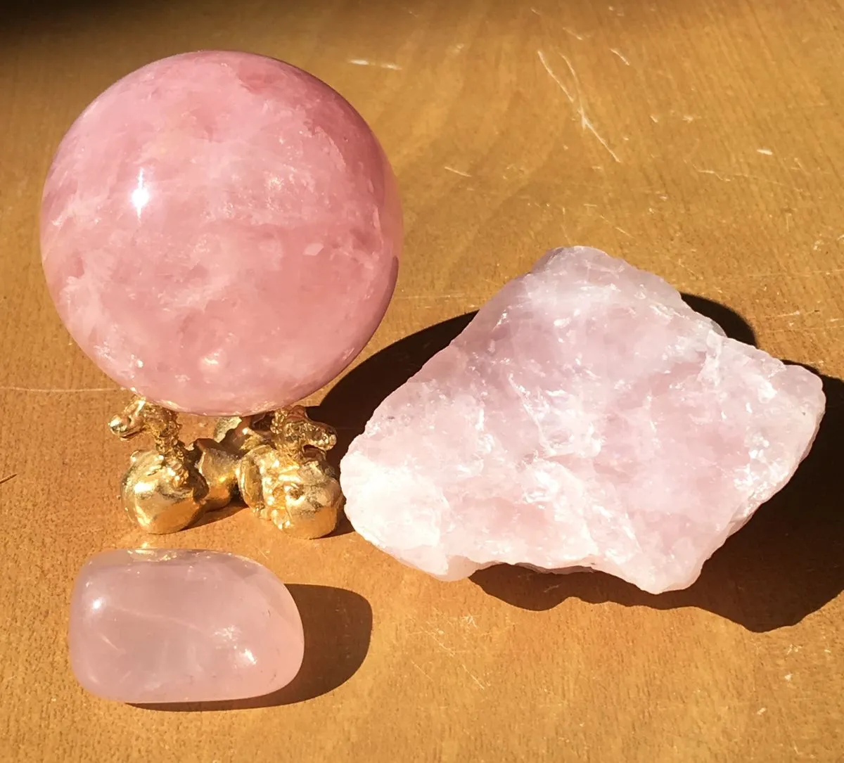 Comparison of real rose quartz with natural cloudiness versus fake brightly colored stones