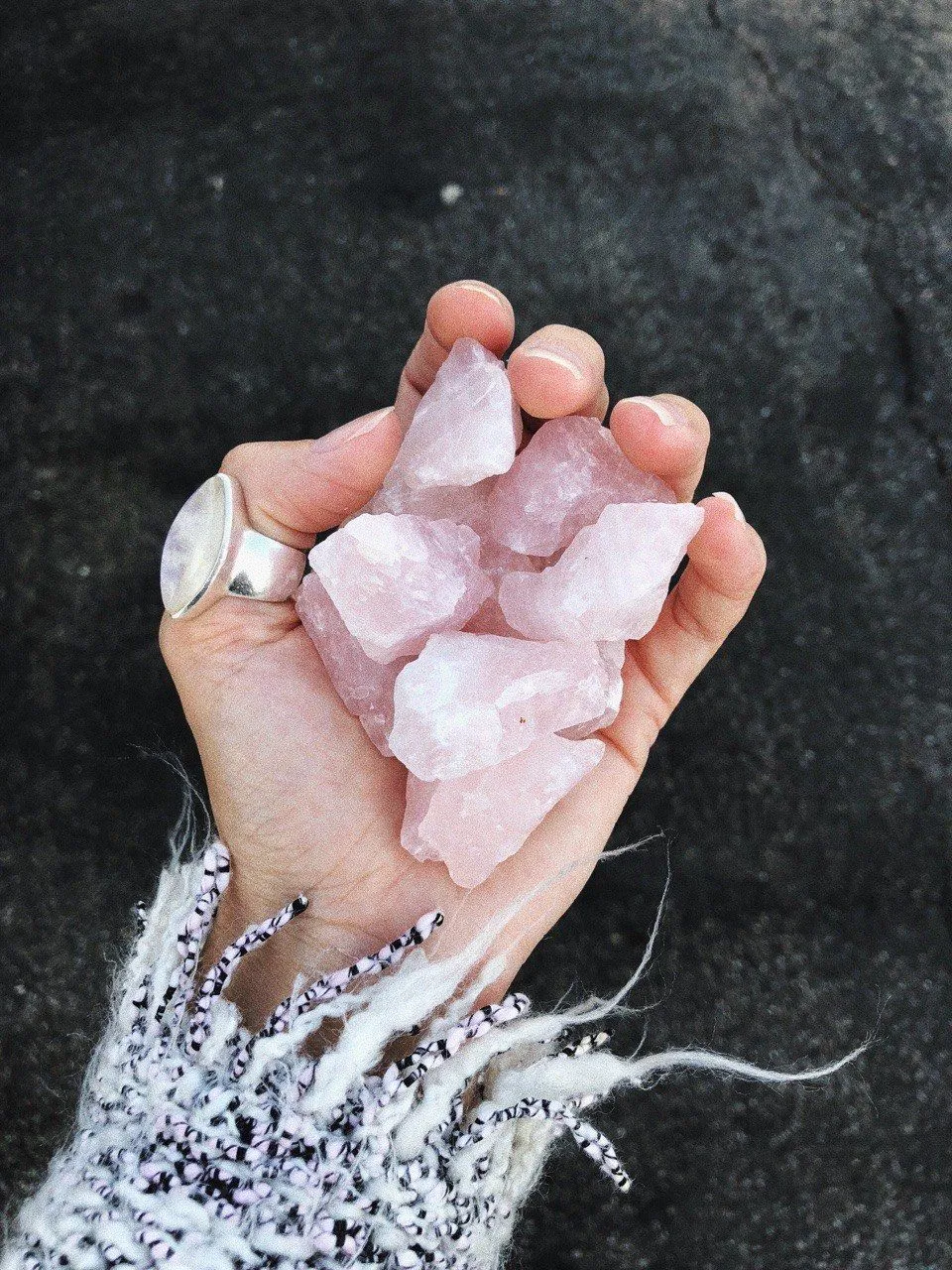 Close-up of raw rose quartz crystal cluster showing natural texture and soft pink coloration