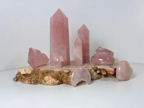 Abstract light-pink background evoking rose quartz energy or a subtle outline of a heart-shaped stone.