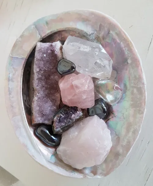 Cleansing rose quartz under running water