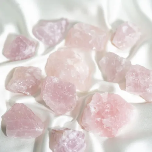Close-up of rose quartz beads with light catching subtle pink hues