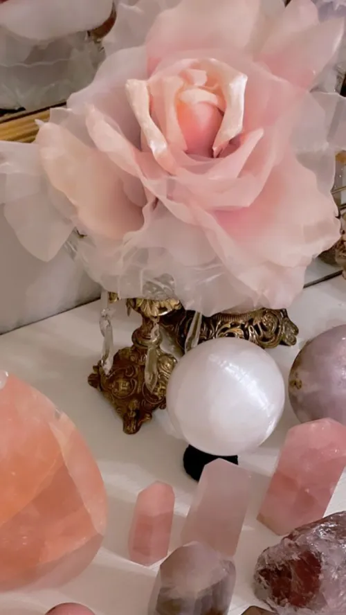 Hand holding rose quartz under gentle tap water