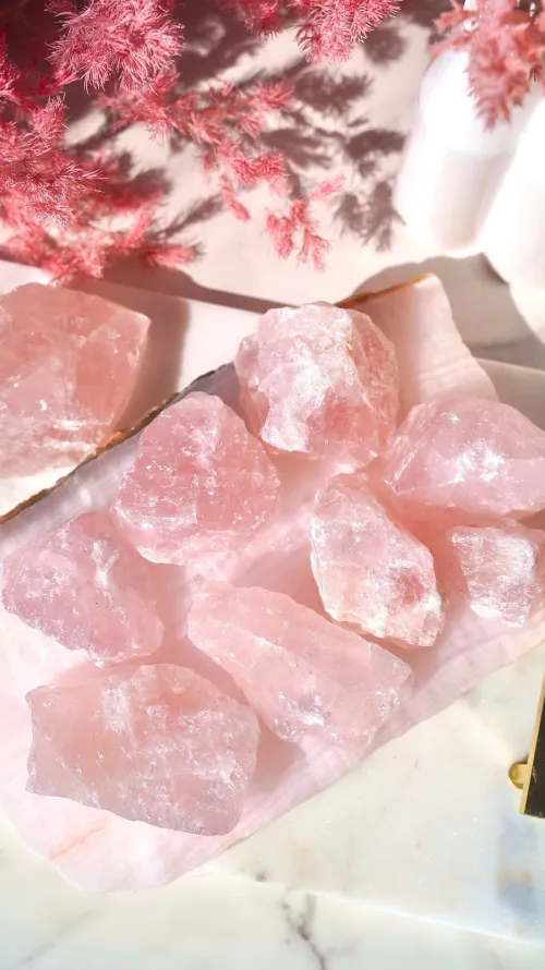 Raw and polished rose quartz comparison showing transformative glow