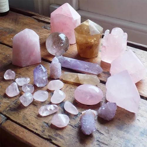 Tumbled rose quartz stones resting in an open hand